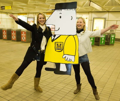 Hello, Ken: Students Marie-Claire Bosomworth and Alexandra Burton pictured with a life-sized Metro Ken illustration at Central station Metro ticket hall in Newcastle