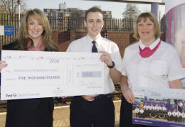 First Capital Connect MD Elaine Holt hands over the cheque to the now fully-clothed Simon Cowley and Mandy Hill.