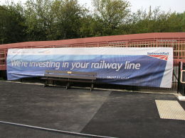 Network Rail banner 'we're investing in your railway line' at Charlbury